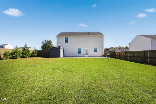 a view of a house with a backyard