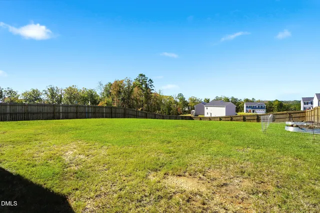 a view of yard with swimming pool and green space