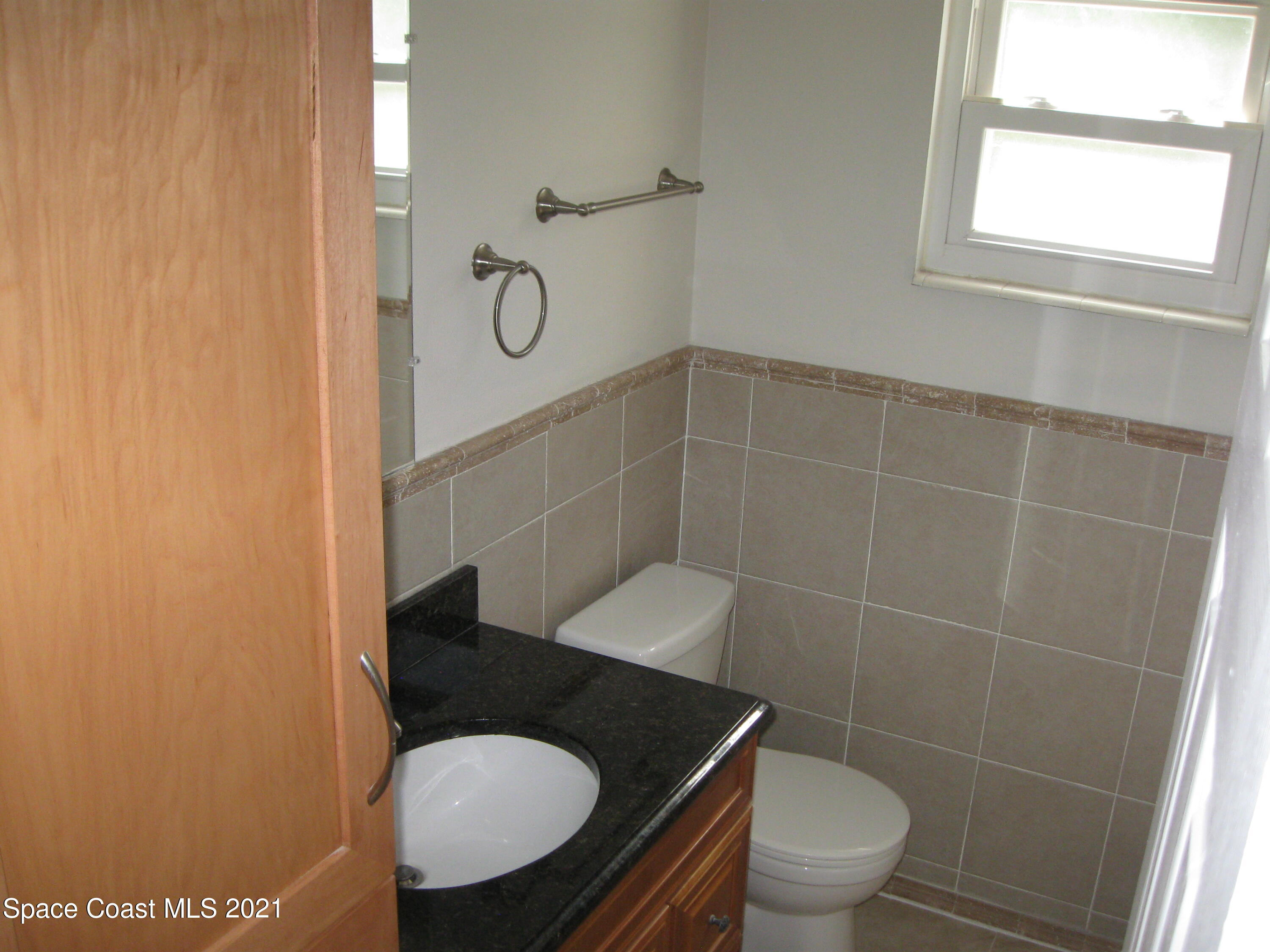 770 Sandgate Street Merritt Island, FL 32953 - Photo 14 of 22 a bathroom with a toilet and a sink