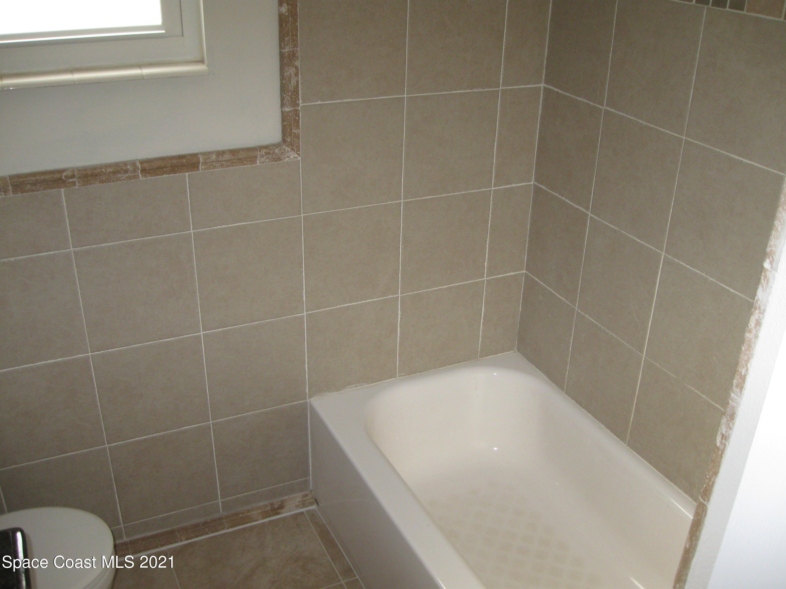 770 Sandgate Street Merritt Island, FL 32953 - Photo 15 of 22 a bathroom with a bathtub