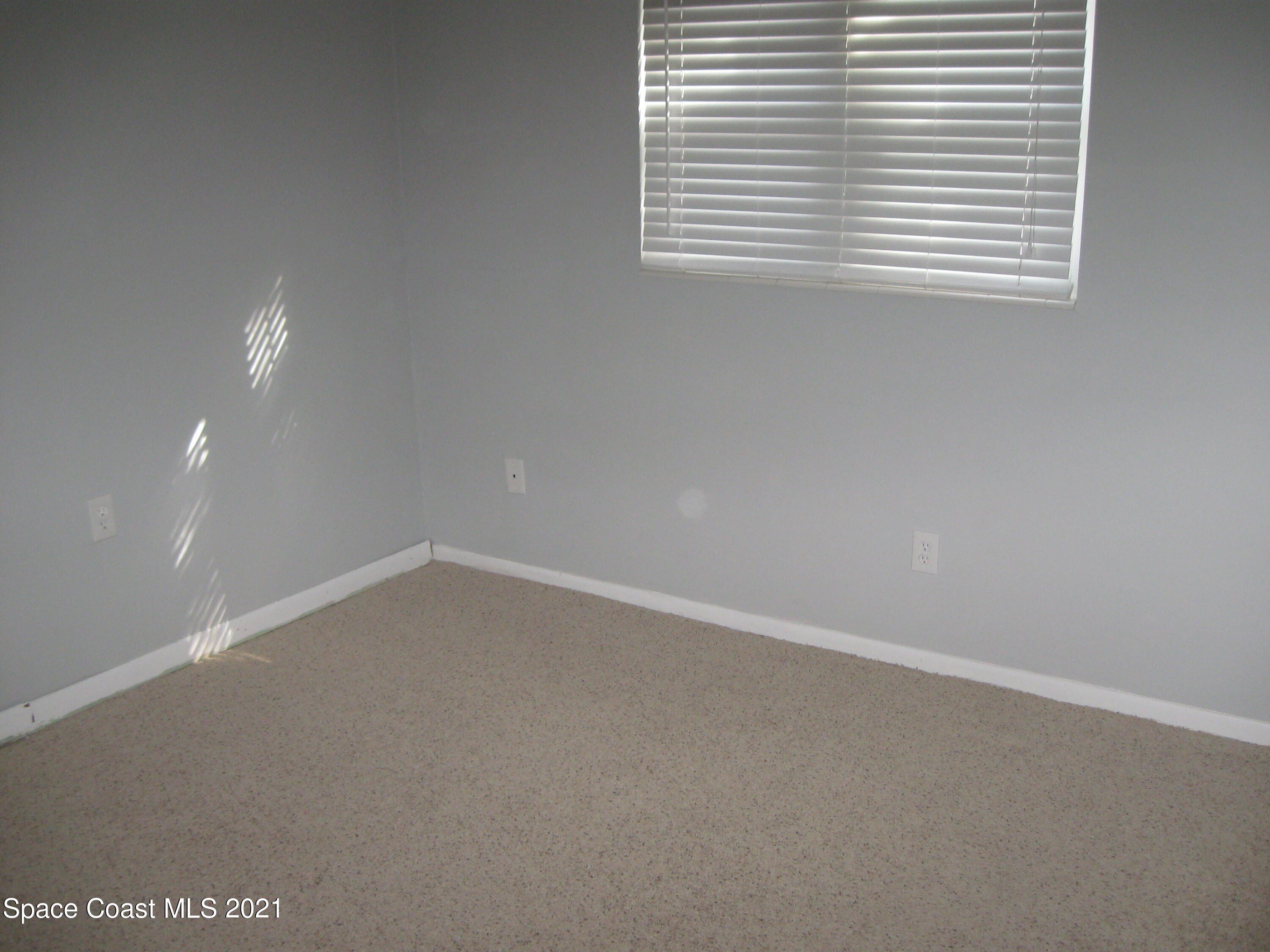 770 Sandgate Street Merritt Island, FL 32953 - Photo 17 of 22 a view of an empty room with a window