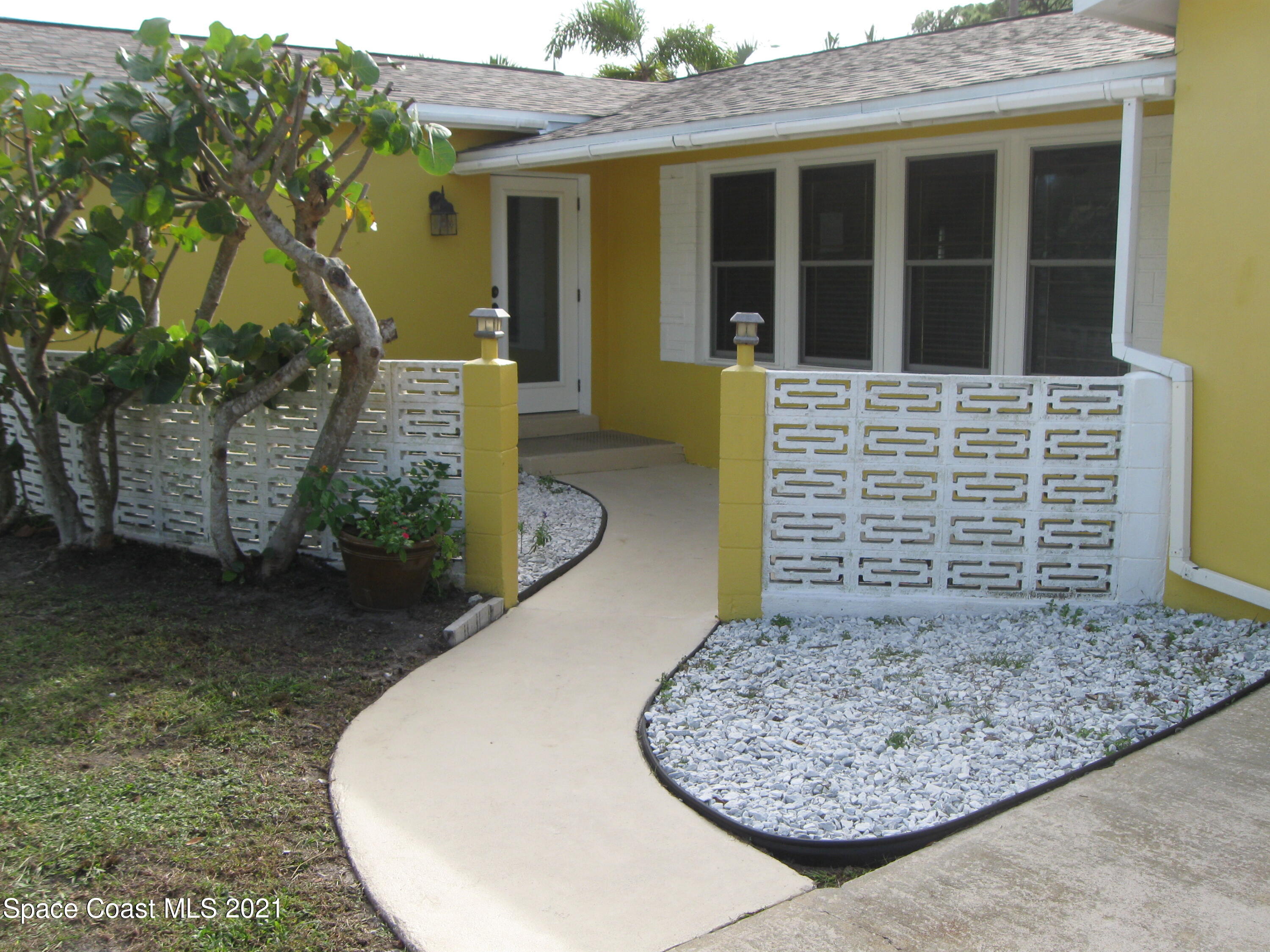 770 Sandgate Street Merritt Island, FL 32953 - Photo 3 of 22 front view of a house with a garden