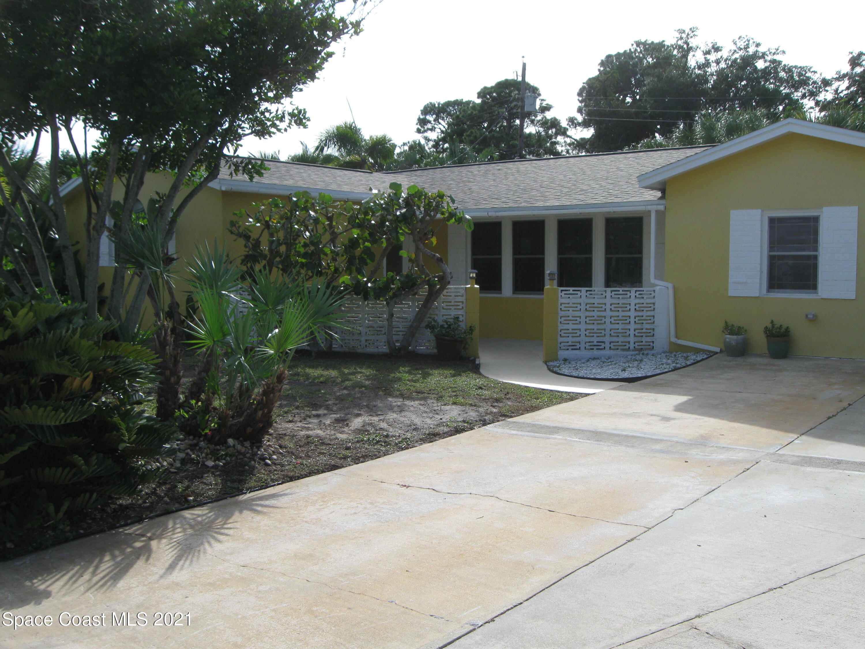 770 Sandgate Street Merritt Island, FL 32953 - Photo 5 of 22 a front view of a house with garden