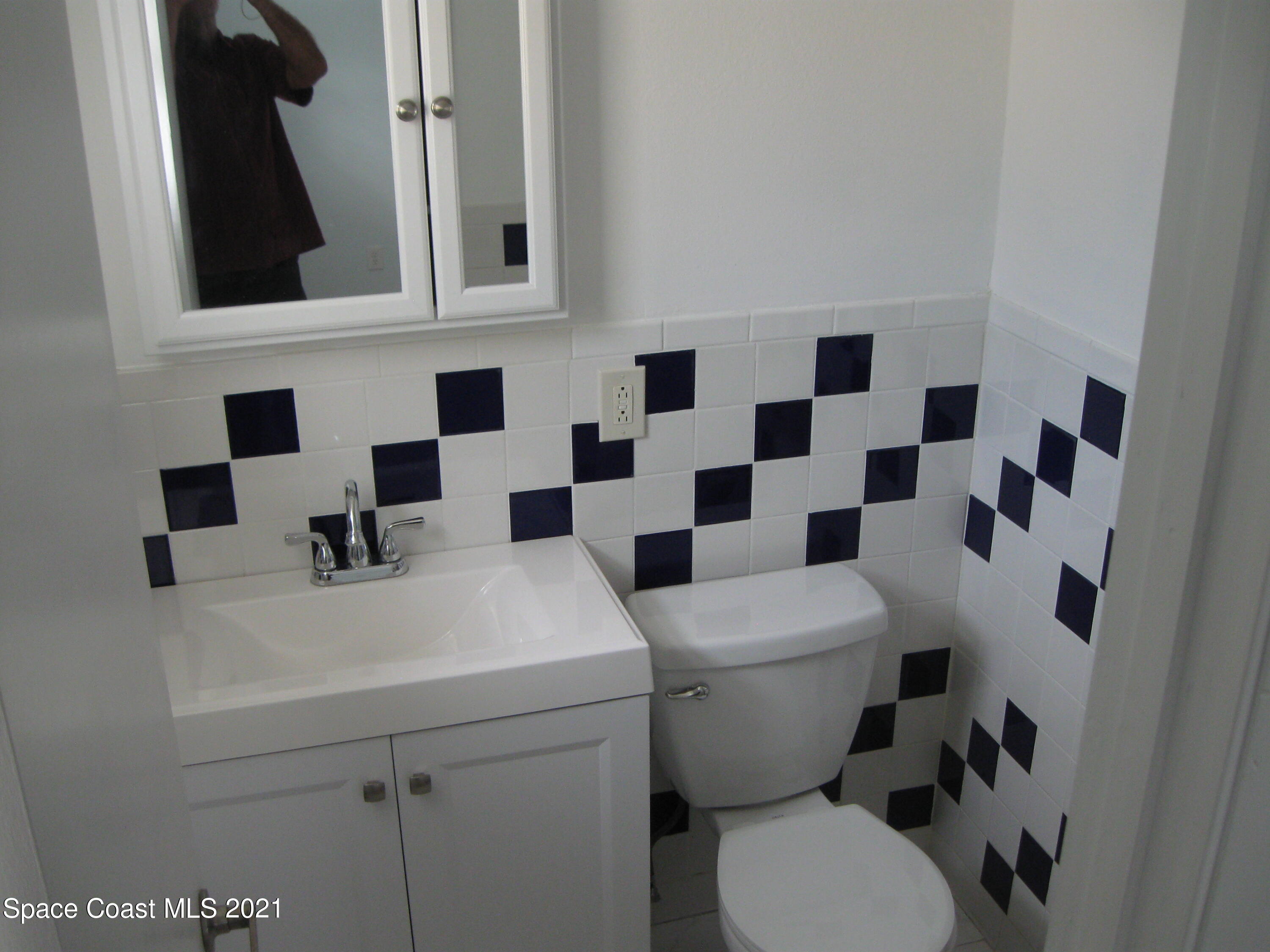 770 Sandgate Street Merritt Island, FL 32953 - Photo 9 of 22 a white toilet sitting next to a bathroom sink