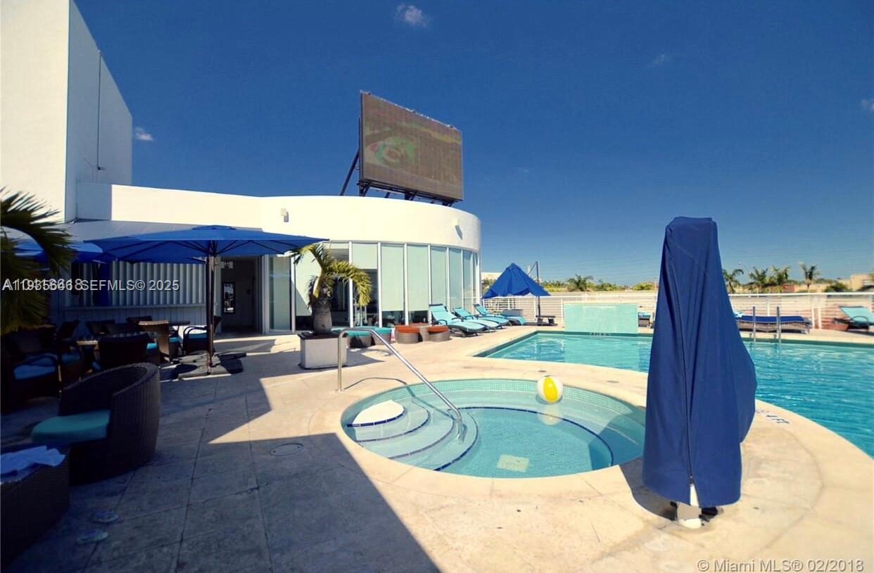 1750 Northwest 107th Avenue, Unit R508 Sweetwater, FL 33172 - Photo 11 of 15 a view of a swimming pool with sitting area