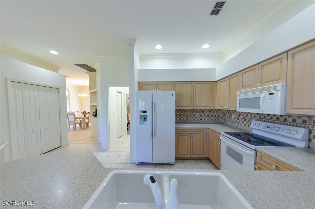 11142 Wine Palm Road Fort Myers, FL 33966 - Photo 12 of 42 a kitchen with a refrigerator and a sink