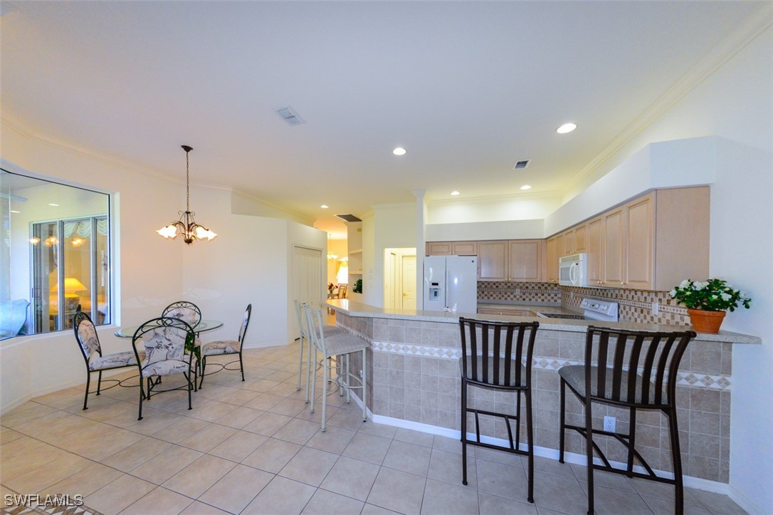 11142 Wine Palm Road Fort Myers, FL 33966 - Photo 14 of 42 a view of a dining room with furniture and chandelier