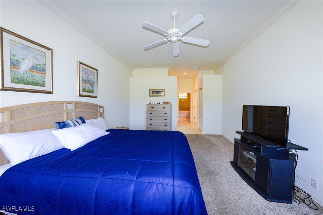 11142 Wine Palm Road Fort Myers, FL 33966 - Photo 21 of 42 a bedroom with a bed and a flat screen tv