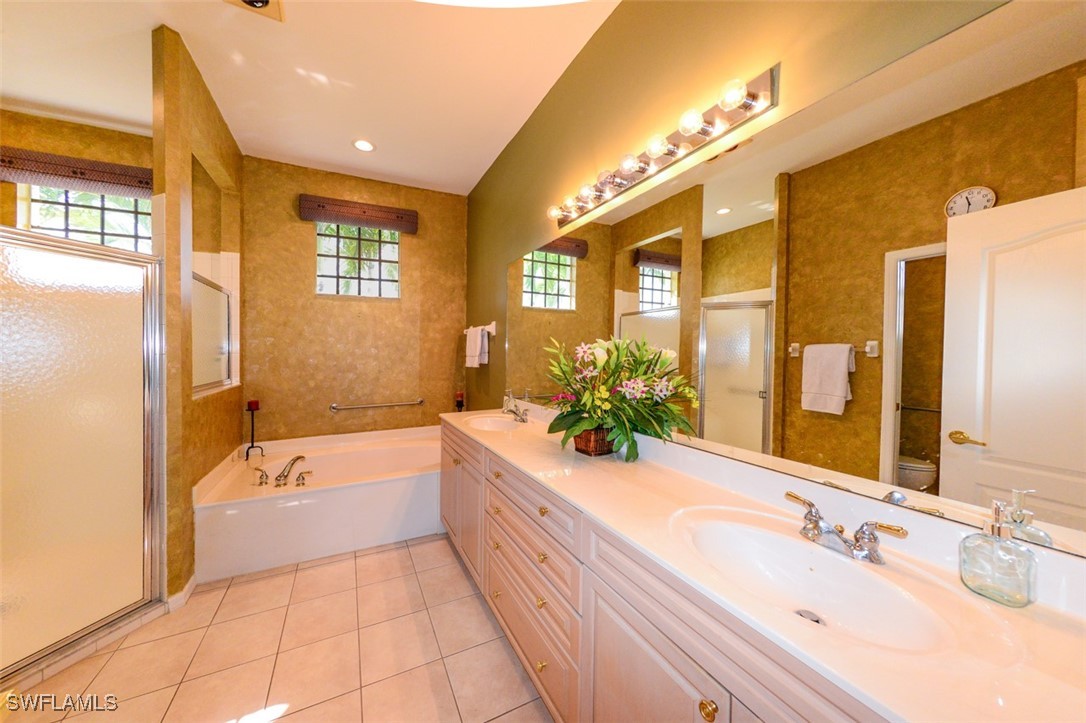 11142 Wine Palm Road Fort Myers, FL 33966 - Photo 25 of 42 a spacious bathroom with a tub sink and mirror
