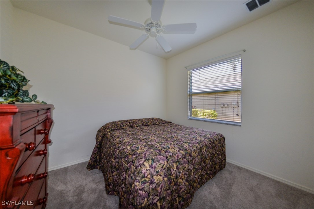11142 Wine Palm Road Fort Myers, FL 33966 - Photo 26 of 42 a bedroom with a bed and a window