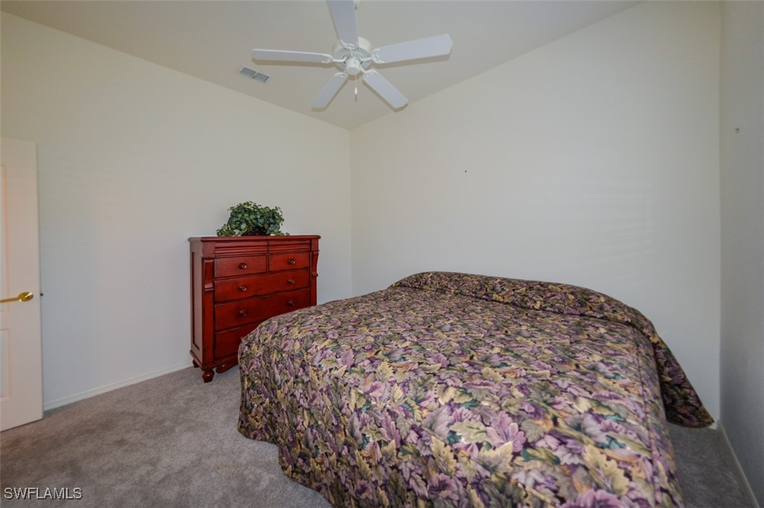 11142 Wine Palm Road Fort Myers, FL 33966 - Photo 27 of 42 a bedroom with a bed and a dresser