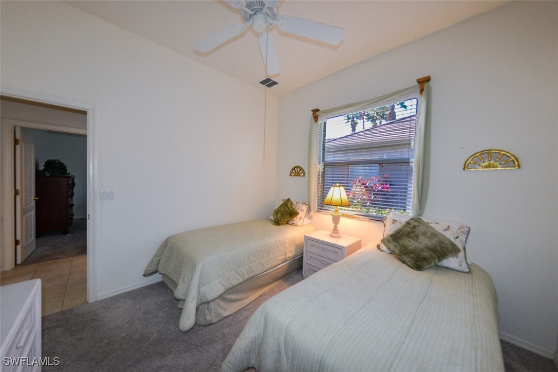 11142 Wine Palm Road Fort Myers, FL 33966 - Photo 28 of 42 a bedroom with two beds and a dresser