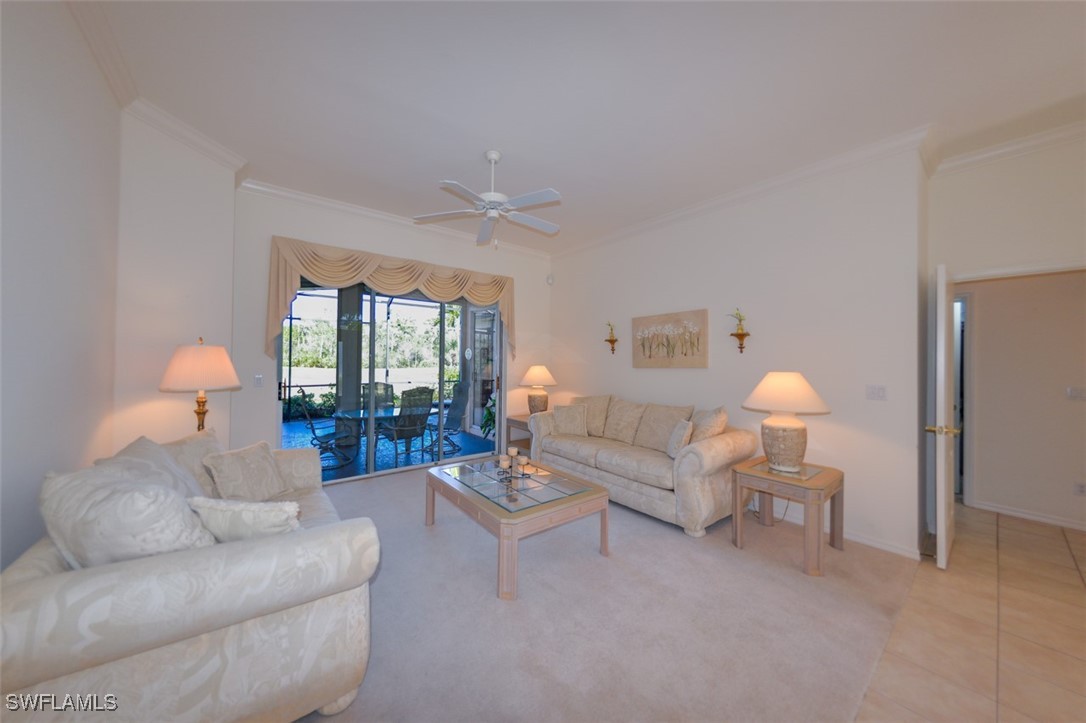 11142 Wine Palm Road Fort Myers, FL 33966 - Photo 4 of 42 a living room with furniture a lamp and a large window