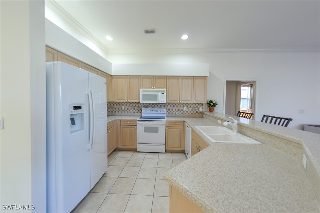 11142 Wine Palm Road Fort Myers, FL 33966 - Photo 10 of 42 a large white kitchen with cabinets