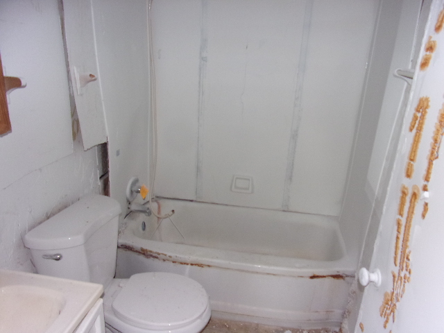 104 Algonquin Road Marquette Heights, IL 61554 - Photo 8 of 12 a white toilet sitting next to a bath tub