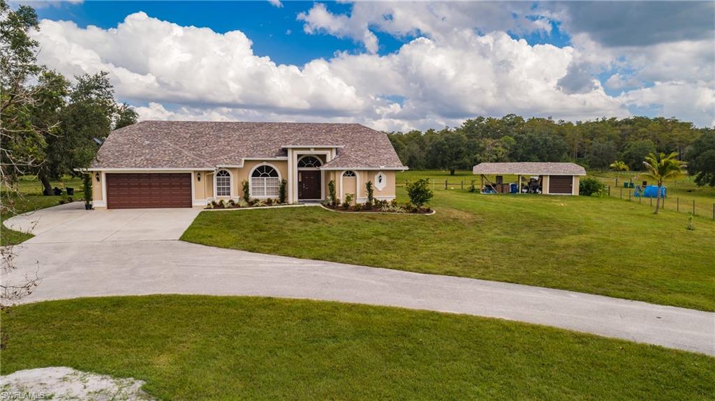 3881 Packinghouse Road Alva, FL 33920 - Photo 1 of 35 a view of a house with a big yard and sitting area