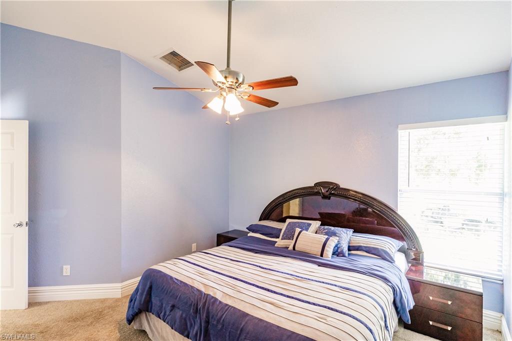 3881 Packinghouse Road Alva, FL 33920 - Photo 19 of 35 a bedroom with a bed and a chandelier