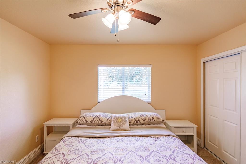 3881 Packinghouse Road Alva, FL 33920 - Photo 22 of 35 a bedroom with a large bed and a window