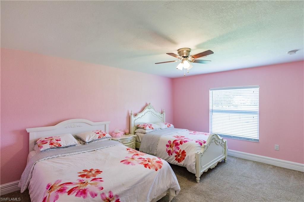 3881 Packinghouse Road Alva, FL 33920 - Photo 23 of 35 a bedroom with a bed and a ceiling fan
