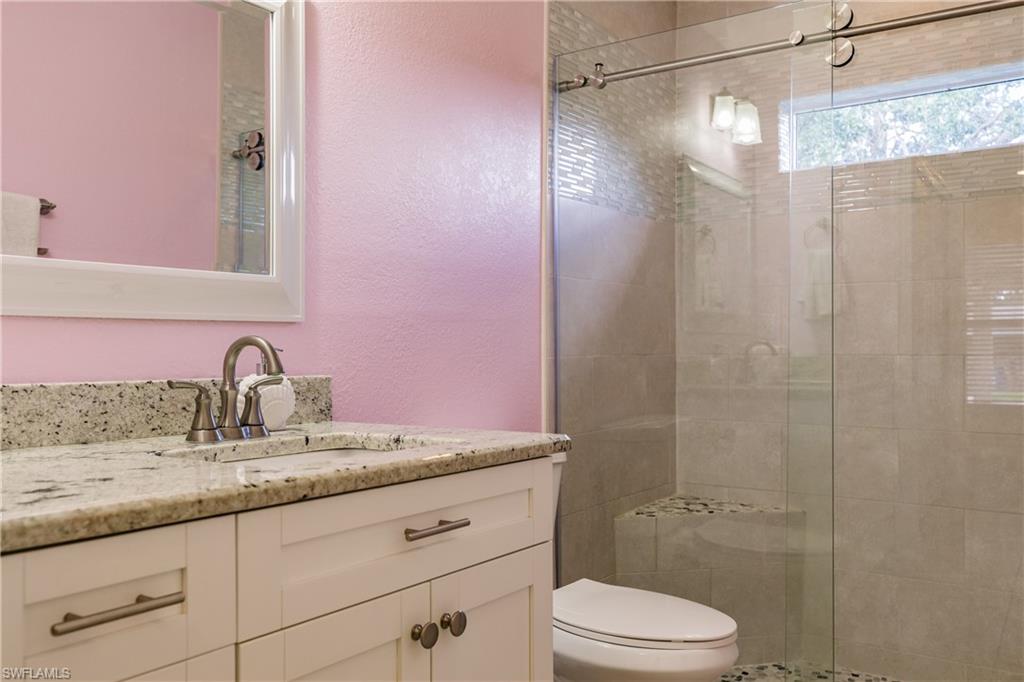 3881 Packinghouse Road Alva, FL 33920 - Photo 24 of 35 a bathroom with a granite countertop sink a toilet and shower
