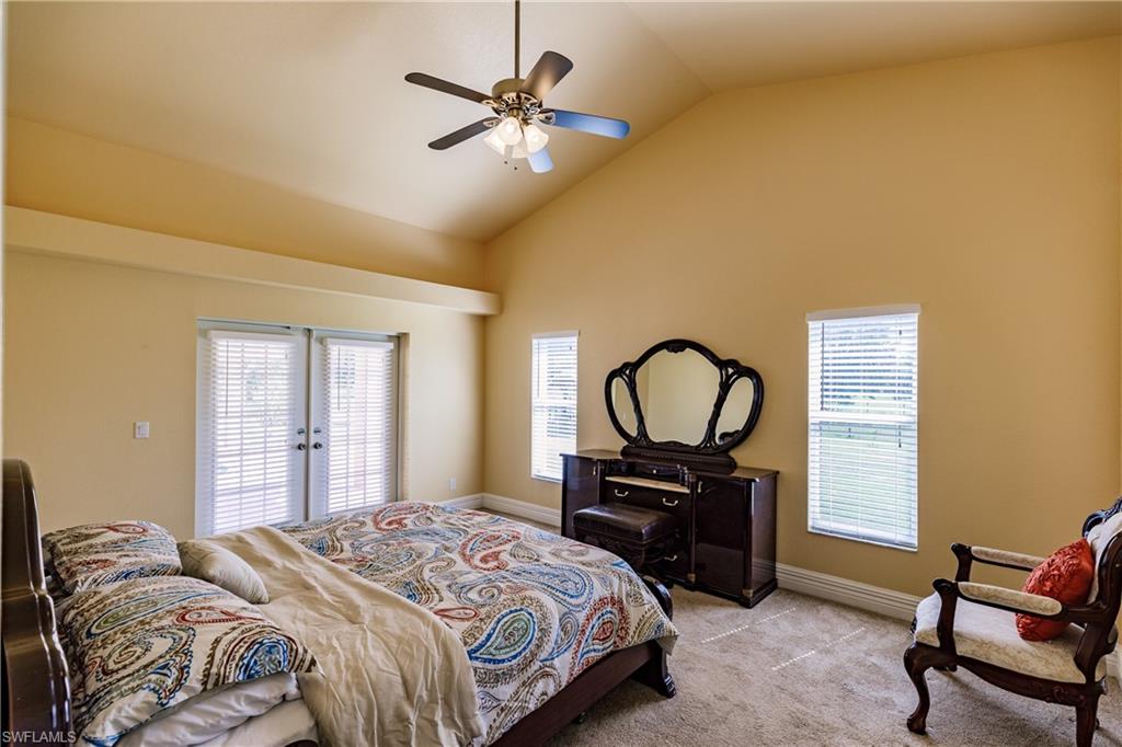 3881 Packinghouse Road Alva, FL 33920 - Photo 25 of 35 a bedroom with a bed and a chandelier