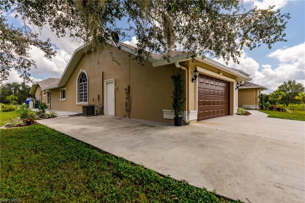 3881 Packinghouse Road Alva, FL 33920 - Photo 31 of 35 a front view of house with yard and trees in the background