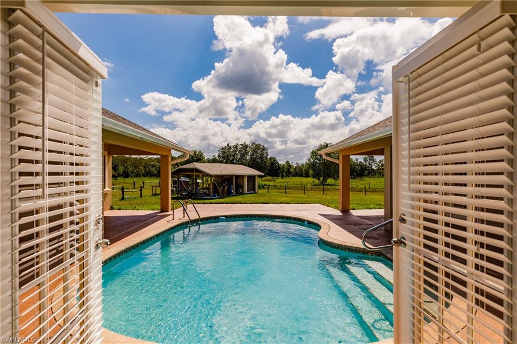3881 Packinghouse Road Alva, FL 33920 - Photo 7 of 35 a view of a swimming pool with a lounge chair