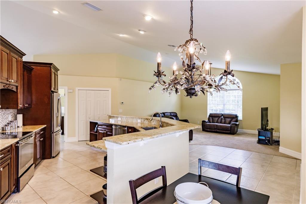 3881 Packinghouse Road Alva, FL 33920 - Photo 8 of 35 a dining room with furniture and a chandelier