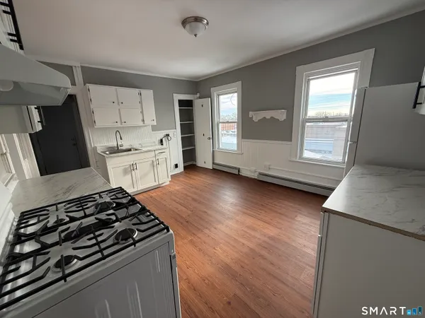 a kitchen with granite countertop a stove and a refrigerator