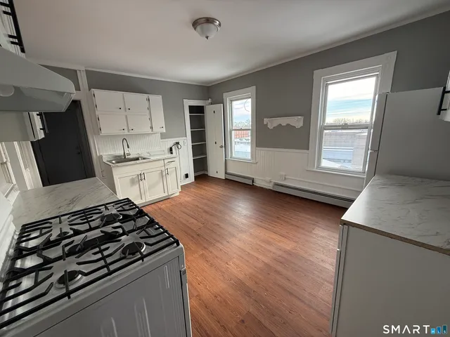 a kitchen with granite countertop a stove and a refrigerator
