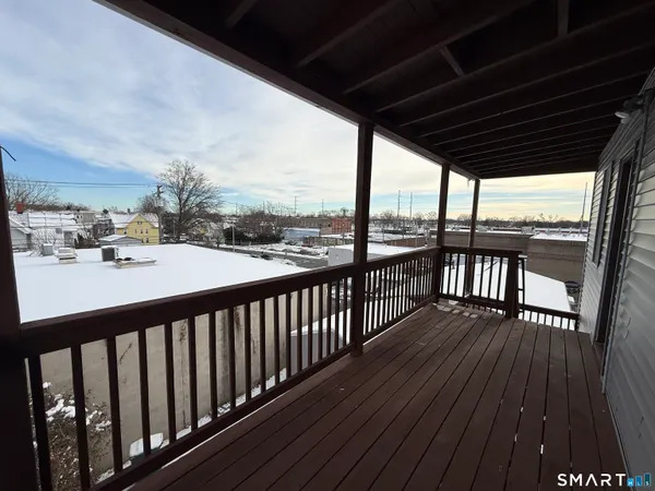 a view of balcony with wooden floor