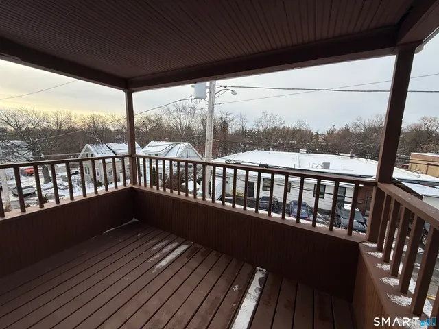 a balcony with wooden floor in outdoor space
