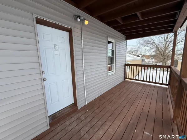 a view of a house with wooden deck