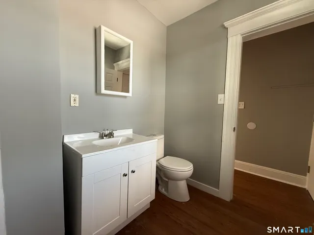 a view of bathroom with sink toilet and vanity