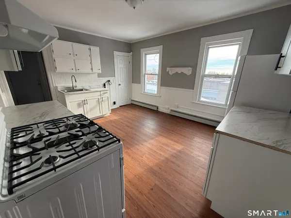 a kitchen with granite countertop a stove and a refrigerator