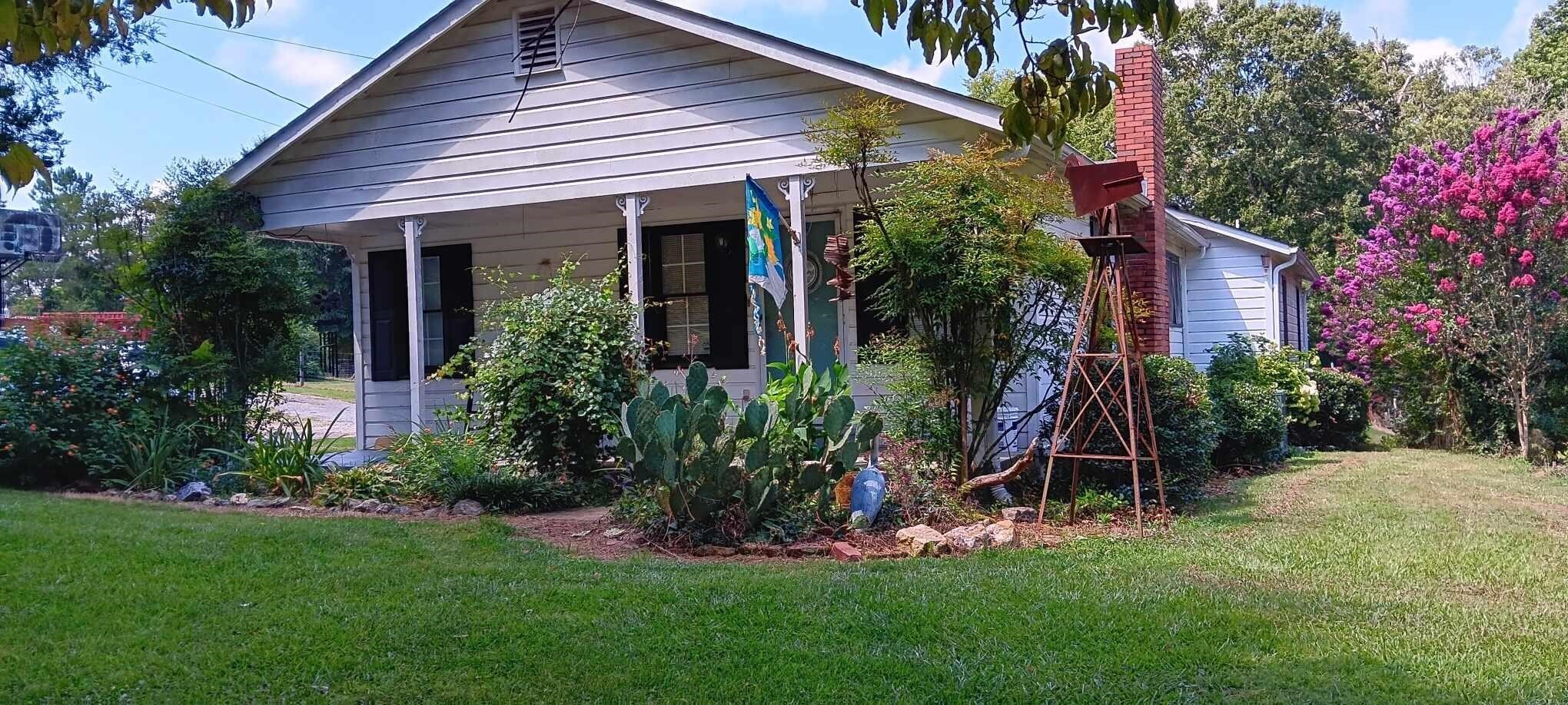 1726 Morrison Camp Ground Road Northeast Rome, GA 30161 - Photo 1 of 1 a view of a house with a yard and plants