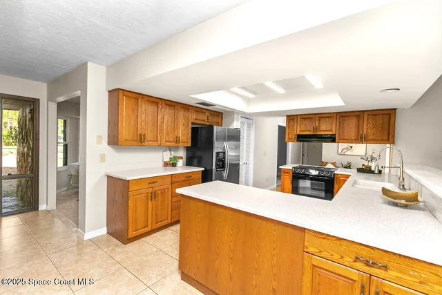 a view of a room with furniture and large windows