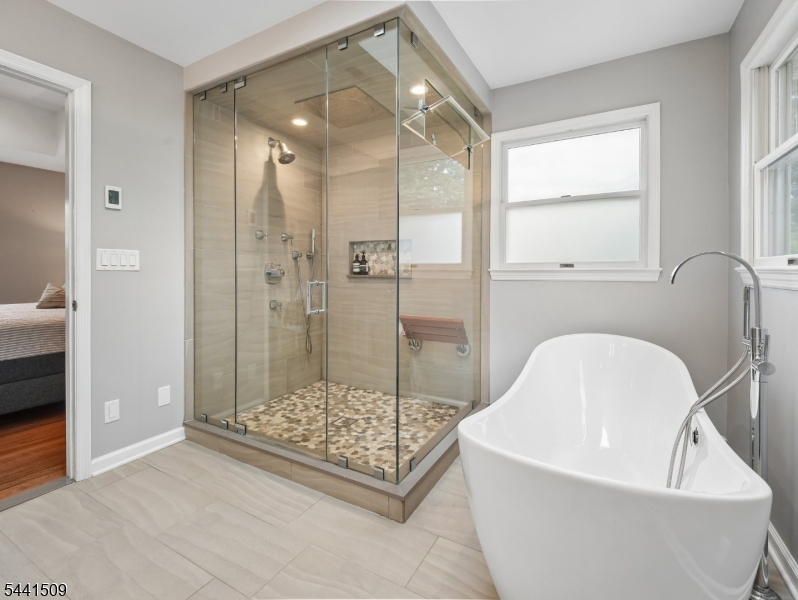 610 River Road Chatham, NJ 07928 - Photo 19 of 42 a bathroom with a bathtub and shower