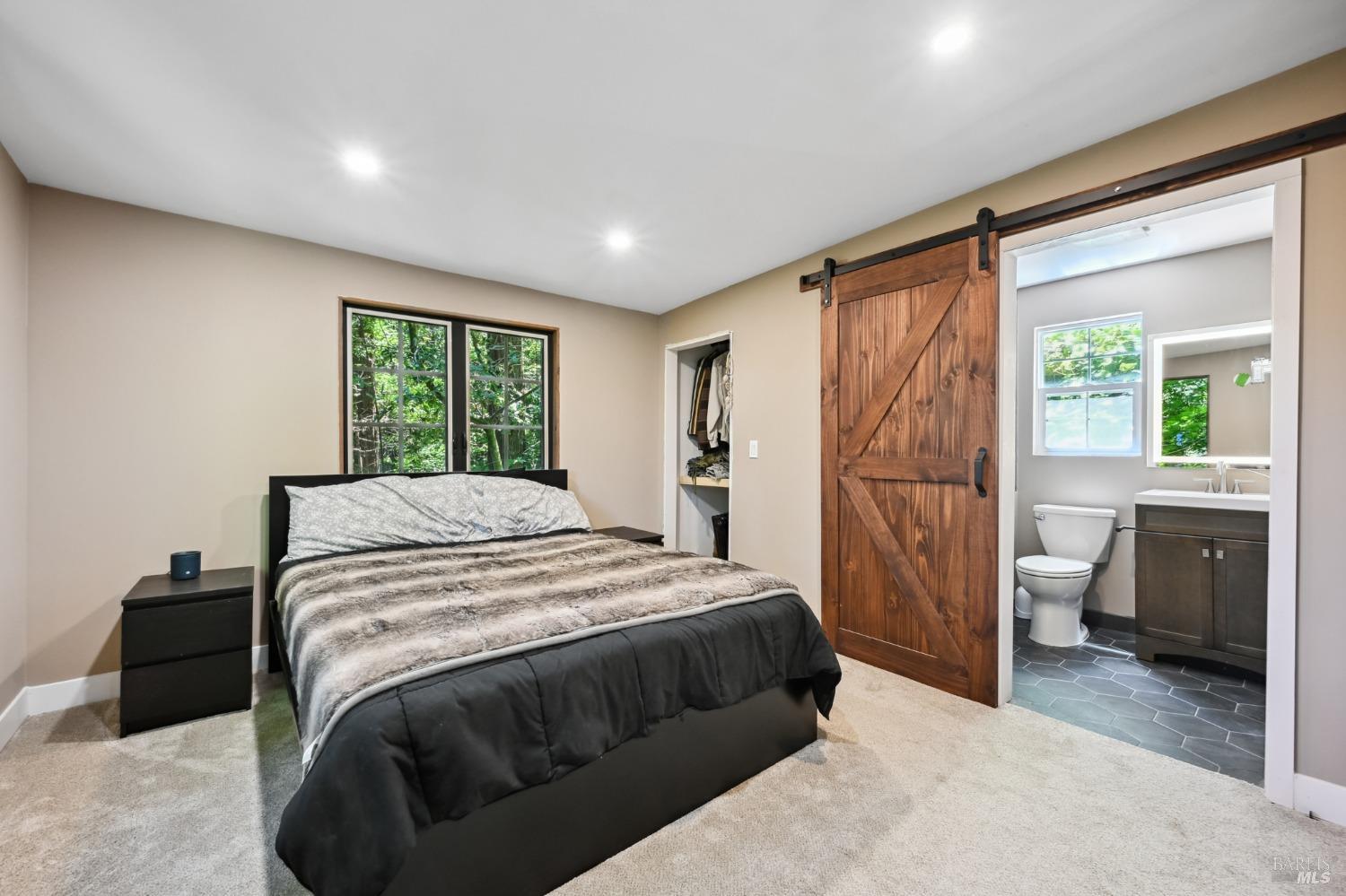 21713 Starrett Hill Drive Monte Rio, CA 95462 - Photo 24 of 50 a bedroom with a bed and a window