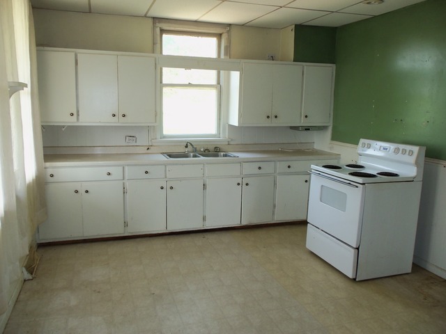 17419 Hebron Road Harvard, IL 60033 - Photo 14 of 22 a kitchen with granite countertop white cabinets and white appliances