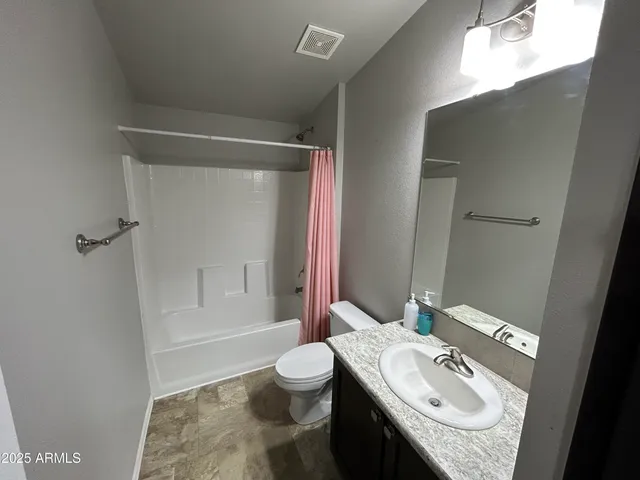 a bedroom with a bed dresser and a window