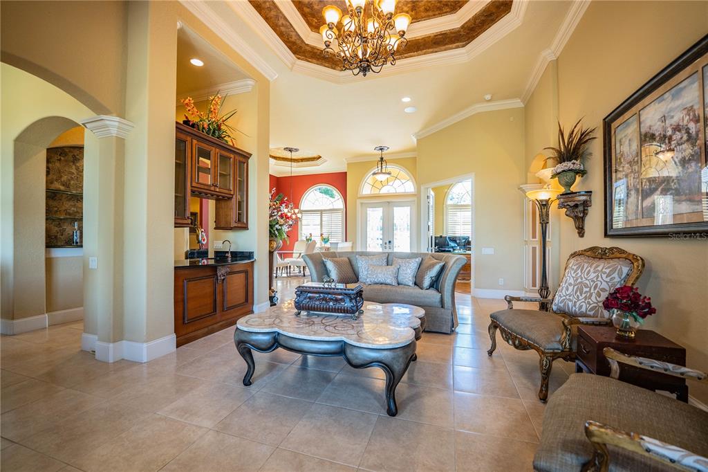 2918 Clubhouse Road Lakeland, FL 33812 - Photo 12 of 47 a living room with furniture and a chandelier