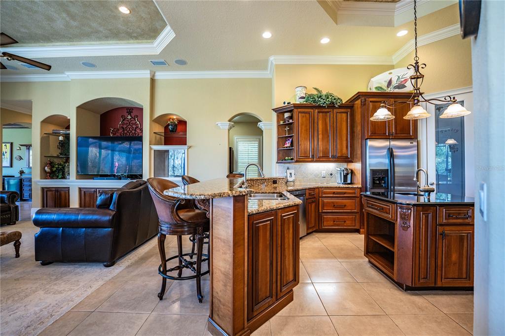 2918 Clubhouse Road Lakeland, FL 33812 - Photo 14 of 47 a kitchen with stainless steel appliances granite countertop a stove and a refrigerator