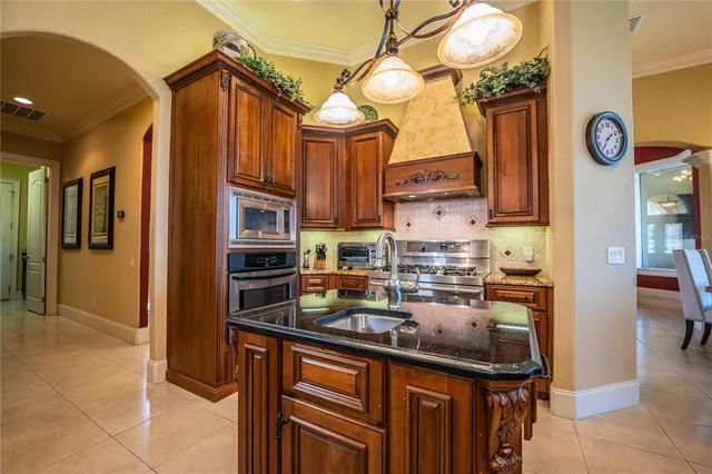 a living room with furniture a ceiling fan and a large window