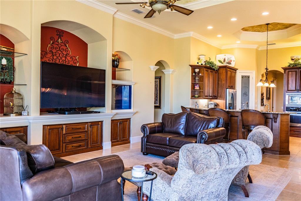 2918 Clubhouse Road Lakeland, FL 33812 - Photo 18 of 47 a living room with furniture a flat screen tv and kitchen view