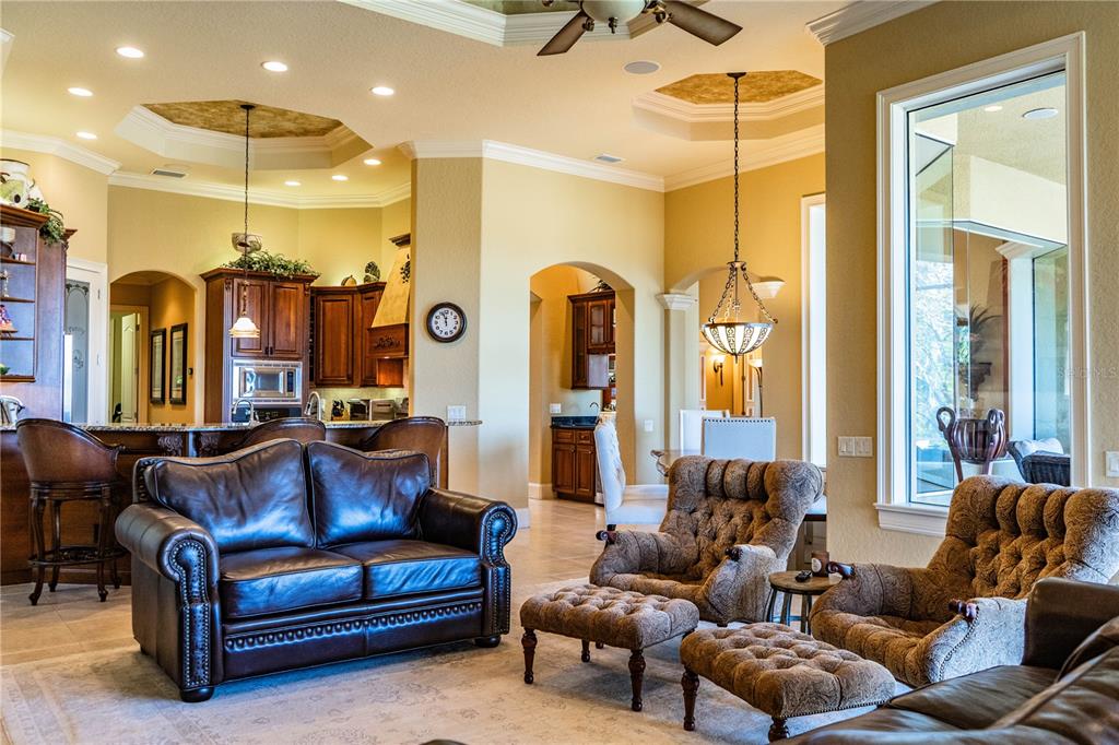 2918 Clubhouse Road Lakeland, FL 33812 - Photo 19 of 47 a living room with furniture a ceiling fan and a large window