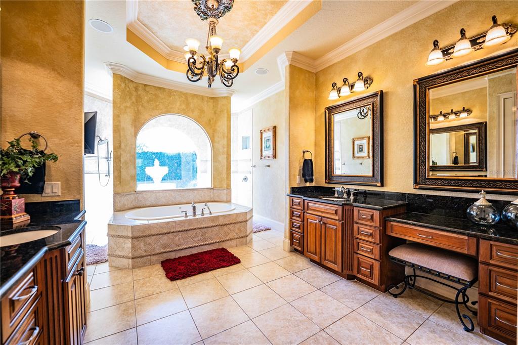 2918 Clubhouse Road Lakeland, FL 33812 - Photo 26 of 47 a spacious bathroom with a mirror a bathtub and a sink