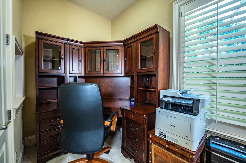 2918 Clubhouse Road Lakeland, FL 33812 - Photo 35 of 47 a view of a workspace with furniture and a window