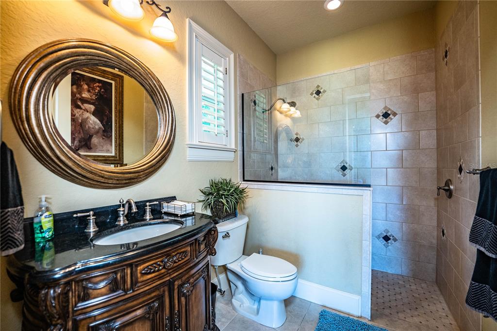 2918 Clubhouse Road Lakeland, FL 33812 - Photo 36 of 47 a bathroom with a sink a mirror and a toilet