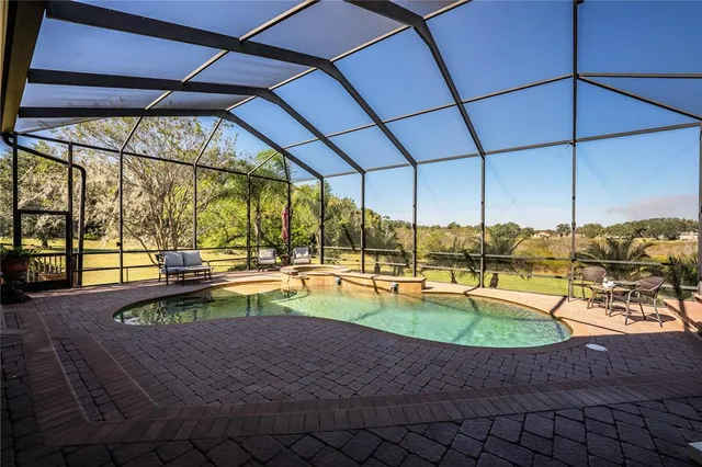 a kitchen with stainless steel appliances granite countertop a refrigerator a stove and a wooden cabinets